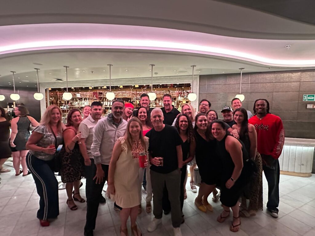 photo at the one of the lounges on a cruise ship capturing everyone on the group trip