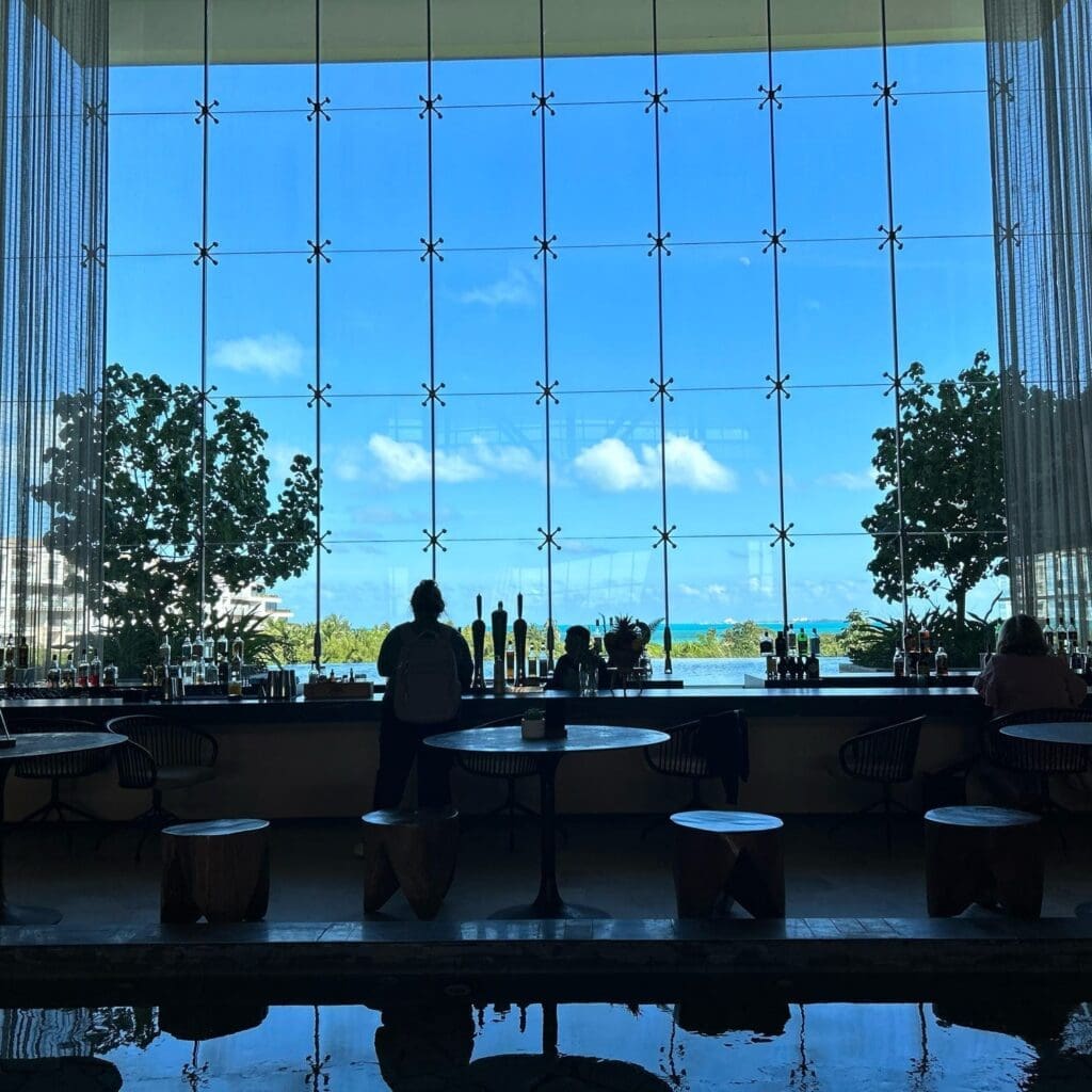 view of the lobby bar looking through the windows towards the sea at an adult-only all-inclusive resort in Cancun