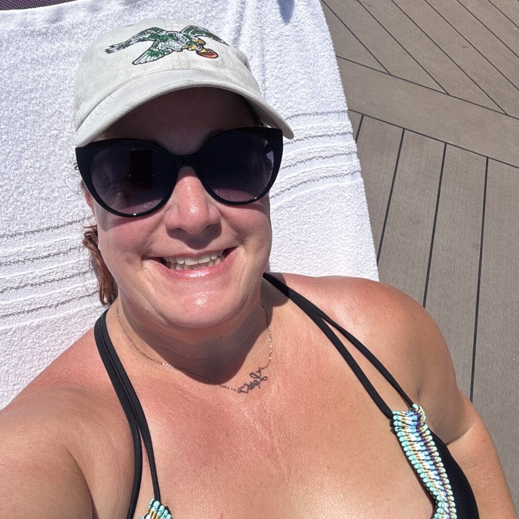 Lori sunbathing on a cruise ship deck while solo cruising